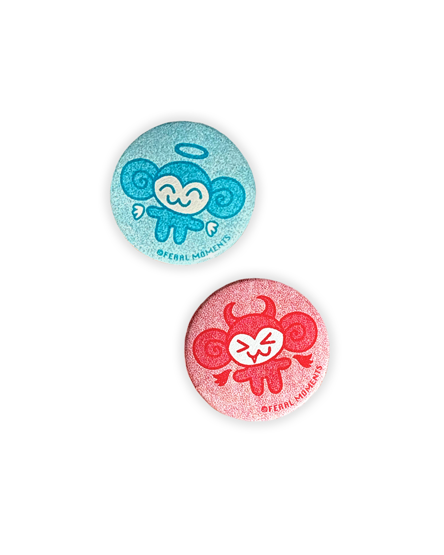 Two colorful buttons with cartoon designs on a white background
