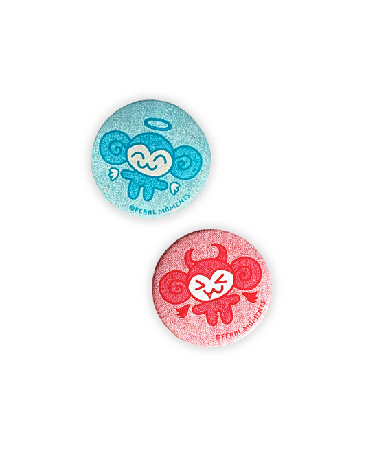Two colorful buttons with cartoon designs on a white background